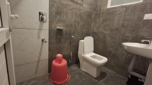 a bathroom with a toilet and a sink at Samudra Retreats Vagamon in Vagamon