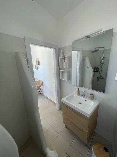a bathroom with a sink and a mirror at CHORA NEST KYTHNOS in Kithnos