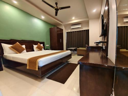 a bedroom with a bed and a flat screen tv at RAILVIEW HOTEL- Nr Platform-1, Railway Station in Bhubaneshwar