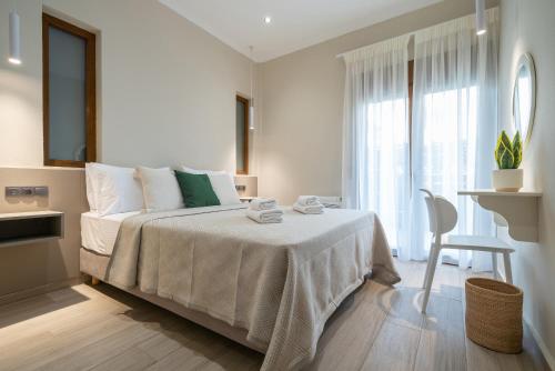 a bedroom with a bed with a table and a chair at Myrina Concept in Myrina