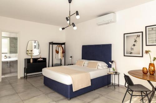 a bedroom with a bed and a table and a bathroom at Bob W Rome San Lorenzo in Rome