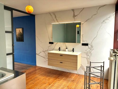 a bathroom with a sink and a mirror at Spacious Design Home with Garden near Centre in Bruges