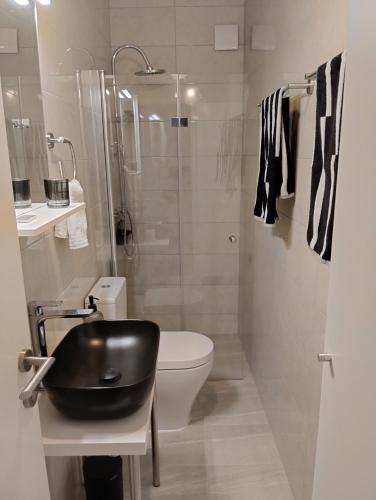 a bathroom with a sink and a toilet and a shower at Keti House Rooms in Vela Luka