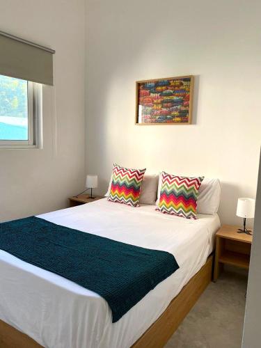 a bedroom with a bed with two pillows on it at Nulacaz 2 - Centrally located in Rose Hill