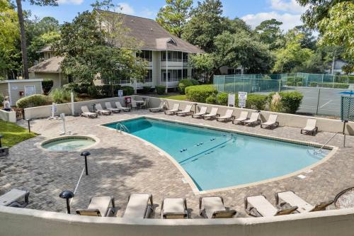 a swimming pool with lounge chairs and a resort at Ocean Creek Amazing Resort Amenities in Myrtle Beach