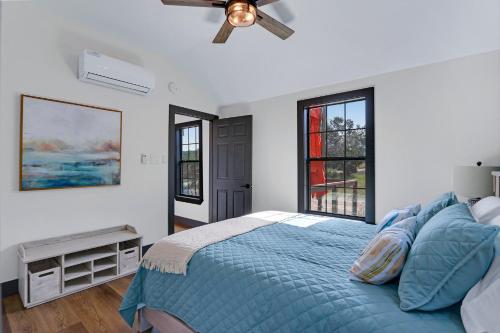 a bedroom with a bed and a ceiling fan at Terlingua at the Bend in Wimberley