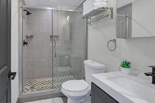 a bathroom with a shower with a toilet and a sink at Terlingua at the Bend in Wimberley