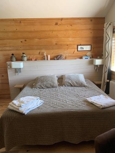 a bedroom with a bed with two towels on it at Villa Crysaële in Menthon-Saint-Bernard