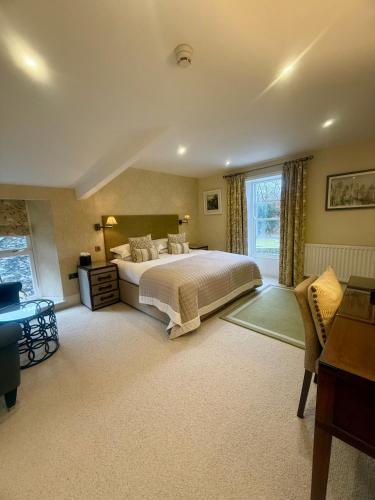 a large bedroom with a bed and a window at The Grasmere Hotel in Grasmere