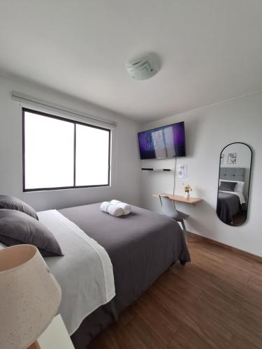 a bedroom with a large bed and a window at Habitación en departamento Compartido - La Paz 504 in Lima