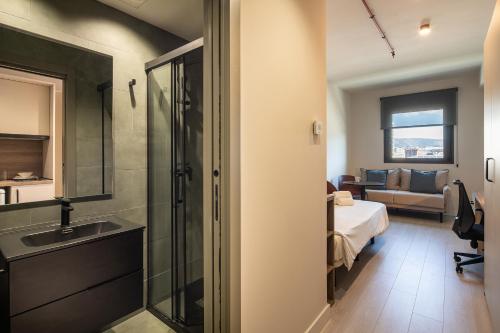 a bathroom with a sink and a shower in a room at Codomo Living Granada in Granada