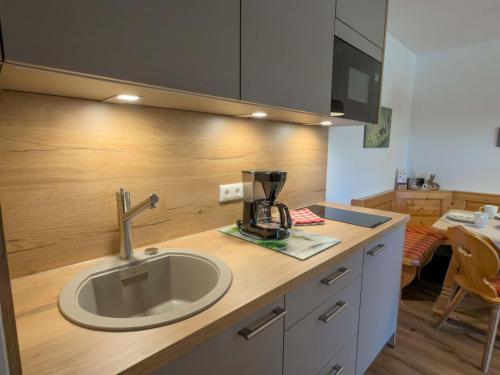 a kitchen counter with a sink and a mixer on it at Landhaus Waldhauser in Schönau am Königssee