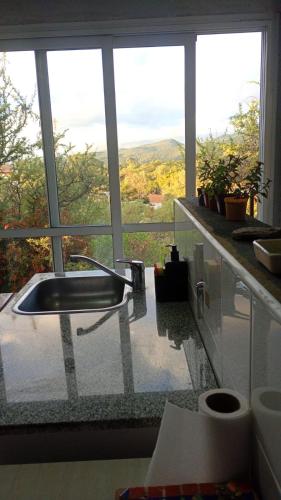 a bathroom with a sink in front of a window at Uritorco Flats in Capilla del Monte