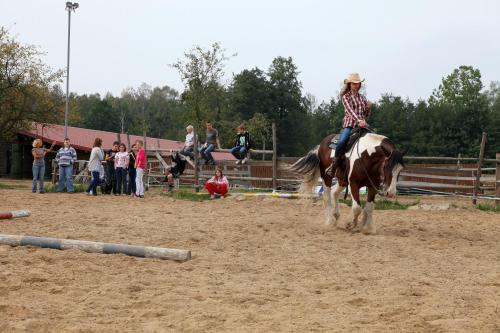 a woman riding a horse in an arena at Wierzbowe Ranczo - blisko Suntago in Budy Michałowskie