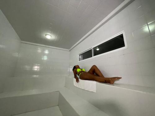 a woman laying in a bath tub in a room at Hotel & Resort Villa del Sol in Tumaco
