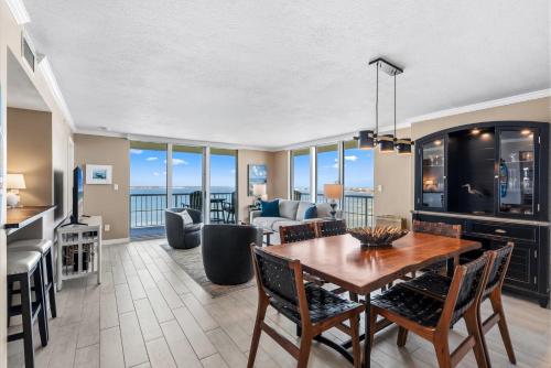 a dining room and living room with a view of the ocean at Tristan Towers Unit 10E in Pensacola Beach