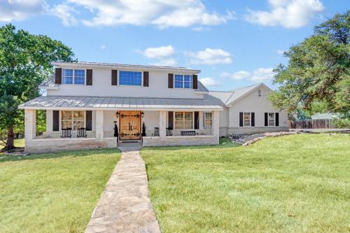 a large white house with a grass yard at Stone Ridge Retreat in Canyon Lake