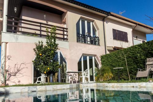 a house with a swimming pool in front of it at Guest H4U Villa Garden & Pool in Póvoa de Varzim