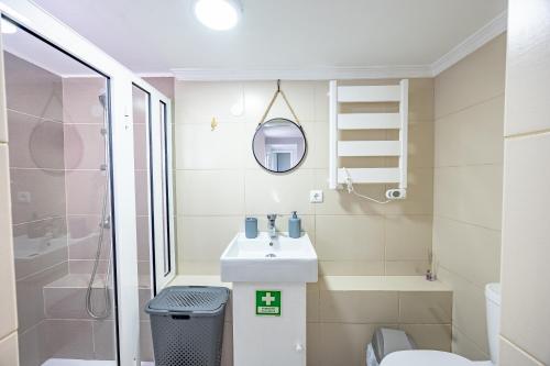 a small bathroom with a sink and a toilet at A Quintinha by YOUR KEY MADEIRA in Santa Cruz