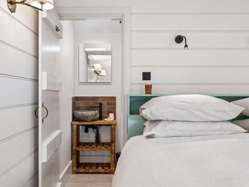a bedroom with white walls and a bed with a table at 1 Bed in Ludlow oc-92768 in Hopton Cangeford