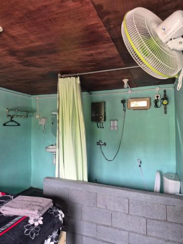 a room with a shower with a fan on the wall at Talaga Tomohon Home Stay and Fishing Pond in Tomohon