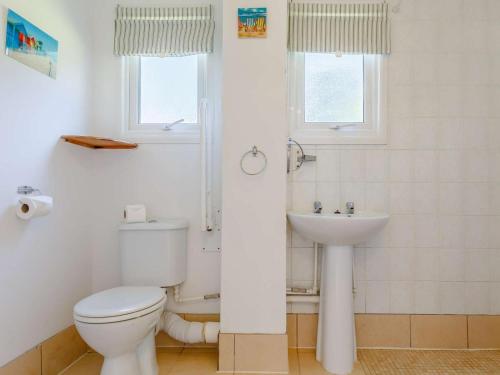 a bathroom with a toilet and a sink at 2 Bed in Saltash oc-88309 in Wotter