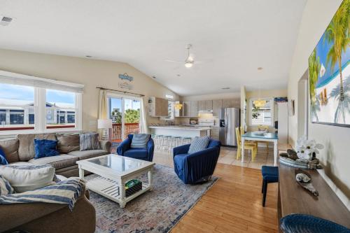 a living room with a couch and a table at 5085 - Knapp's at the Beach in Kill Devil Hills