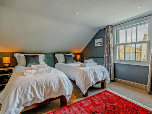 a bedroom with two beds and a window at 2 Bed in Spalding oc-91528 in Surfleet