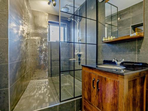 a bathroom with a shower with a sink and a glass shower stall at 2 Bed in Spalding oc-91528 in Surfleet