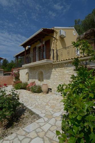 a large house with a balcony on top of it at Villa Adrianna in Longós
