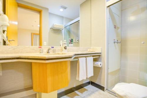 a bathroom with a sink and a shower at Transamerica Executive Faria Lima in São Paulo