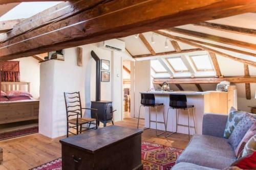 a living room with a couch and a stove at Tolmin center apartments Townhouse & Loft in Tolmin