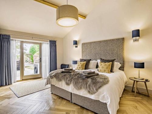 a bedroom with a large bed and a large window at 2 Bed in Driffield oc-88238 in Lund
