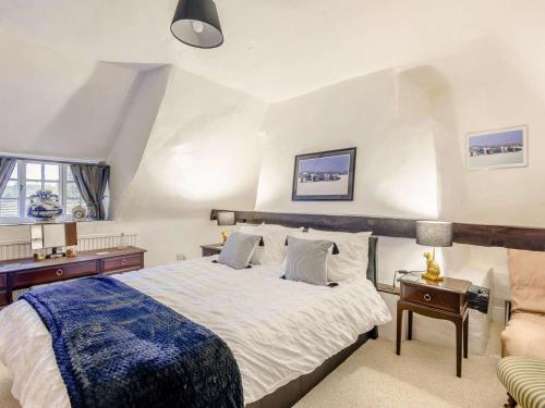 a bedroom with a large bed and a couch at 4 Bed in Oakham oc-86556 in Empingham