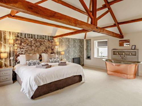 a large bedroom with a large bed and a sink at 3 Bed in Driffield oc-92697 in Lund
