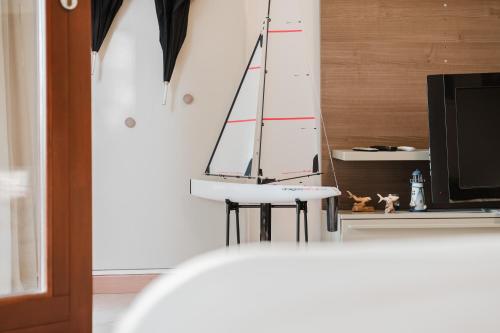 a sailboat is on the wall of a room at Villetta Le Scaje in Torri del Benaco