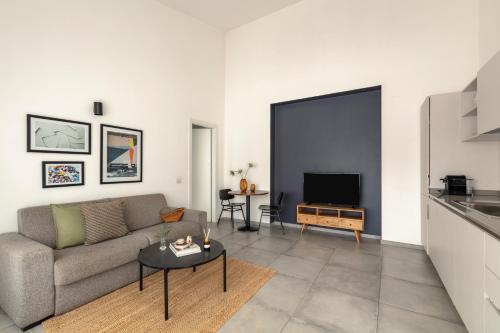 a living room with a couch and a tv at Bob W Rome San Lorenzo in Rome