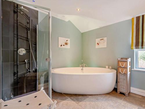 a bath tub in a bathroom with a shower at 4 Bed in Bognor Regis oc-81446 in Bognor Regis
