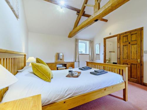 a bedroom with a large white bed with a tray on it at 2 Bed in Doncaster oc-93770 in Mattersey