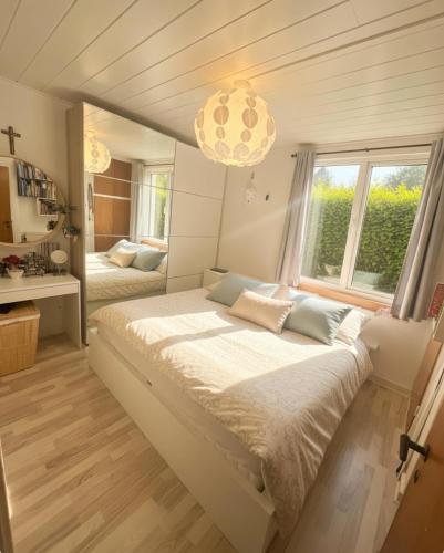 a bedroom with a large bed and a large window at Entire house only 20 min from Copenhagen center in Tåstrup
