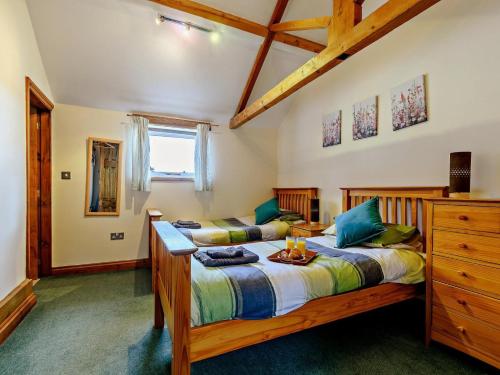 a bedroom with two beds and a dresser at 2 Bed in Doncaster oc-93771 in Mattersey
