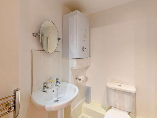 a white bathroom with a toilet and a sink at 1 Bed in Doncaster oc-93572 in Mattersey