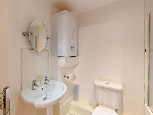 a white bathroom with a toilet and a sink at 1 Bed in Doncaster oc-93571 in Mattersey