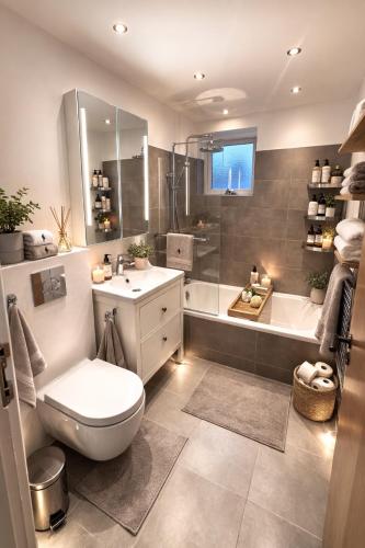 a bathroom with a toilet and a sink and a tub at Entire house only 20 min from Copenhagen center in Tåstrup