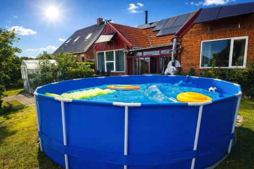 a large blue tub filled with water in front of a house at Entire house only 20 min from Copenhagen center in Tåstrup