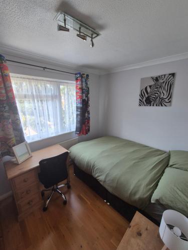 a bedroom with a bed and a desk and a window at Rome avenue in Abingdon