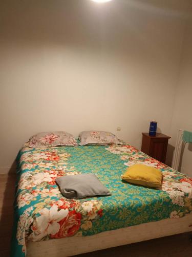 a bed with two pillows sitting on top of it at FamousHouse in Le Havre