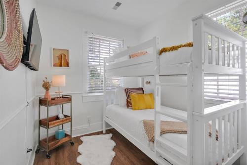a white bunk bed in a white room with a desk at Urban Oasis in Wilmington