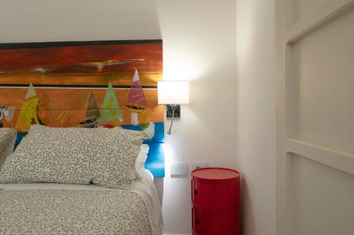 a bedroom with a bed with a painting on the wall at Il Pozzo dei Giganti in Monte San Pietrangeli