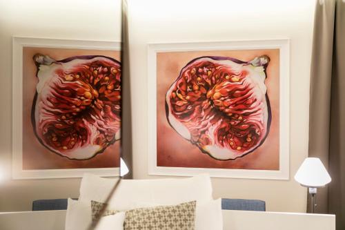 two framed paintings of a pomegranate on a wall at Pytloun Grand Hotel Imperial in Liberec